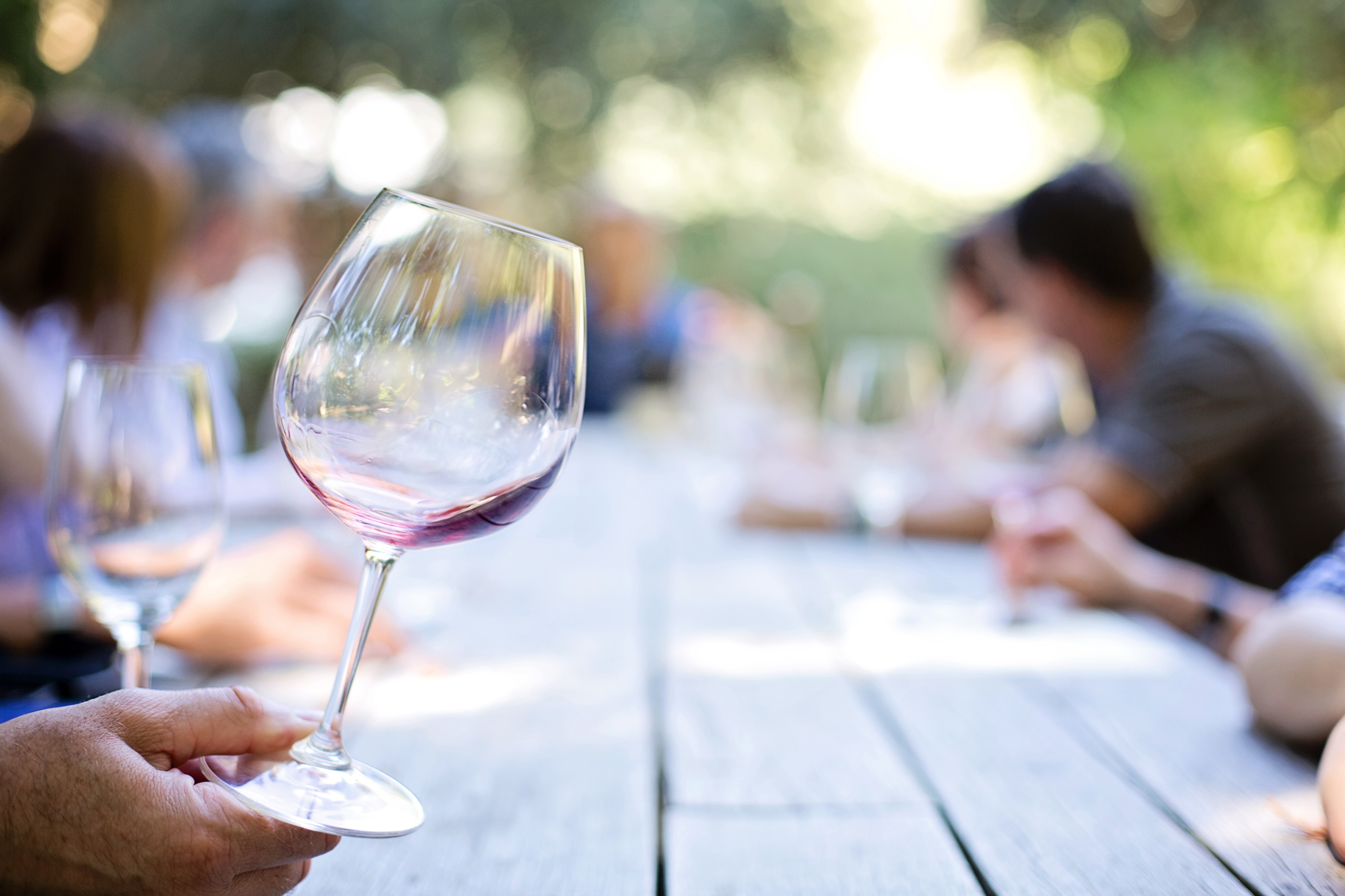 A glass of red wine during an outdoor tasting experience in the Murcia region, reflecting the area’s bodega and wine country day trips.